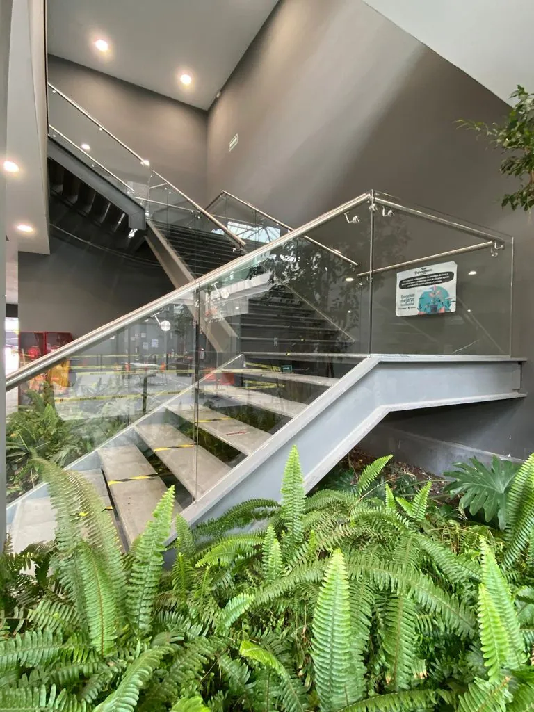 Escalera con barandal de cristal en plaza comercial